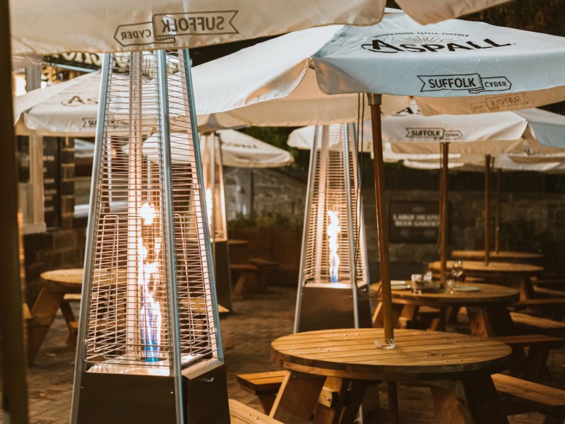 The beer garden at The Horse & Jockey with tables, umbrellas and heaters.