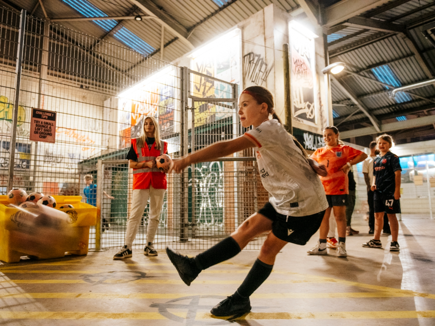 Children playing football at Yard Ball, an indoor football park.