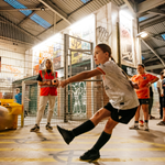 Children playing football at Yard Ball, an indoor football park.