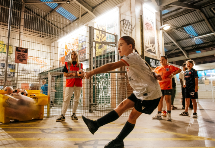 Children playing football at Yard Ball, an indoor football park.