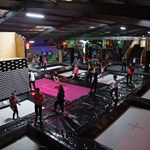 The inside of Jump Inc. with lots of young people having fun on trampolines.