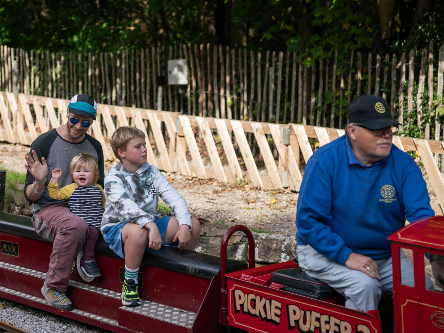 A family rides on a miniature steam train at the Abbeydale Miniature Railway in Sheffield.