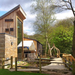 Stone and wood buildings at the J.G. Graves Woodland Discovery Centre.