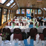 Inside the A&G Passenger Boat with rows of table set up for dining.