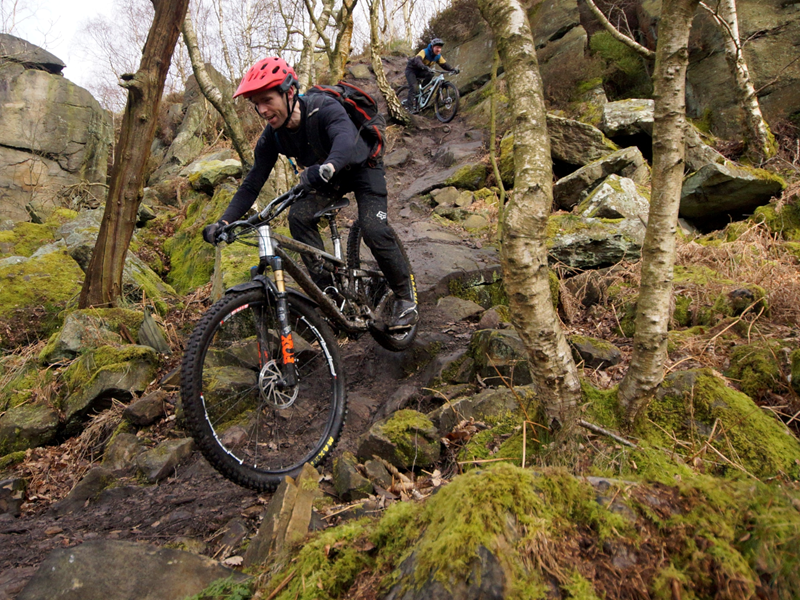 People mountain biking in the countryside.