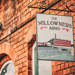 The sign hanging outside The Millowners Arms.