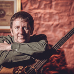 A picture of Daoirí Farrell holding a  bouzouki .