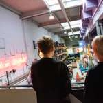 two people stood on a walkway looking down into Kelham Island Museum.