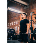 A man lifting weights at a gym.