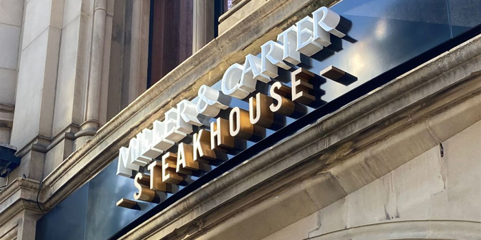 The Miller & Carter Steakhouse sign above the entrance to the restaurant.