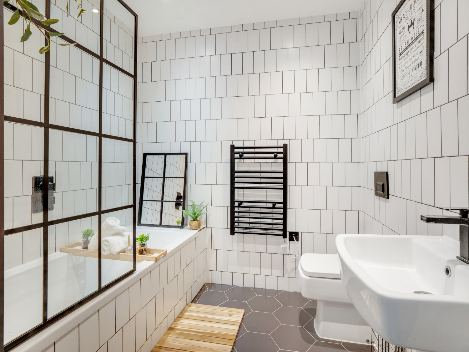 Modern bathroom with full amenities, including a sink, toilet, shower, and contemporary fixtures.