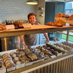 A member of staff stands behind the counter at Crumb.