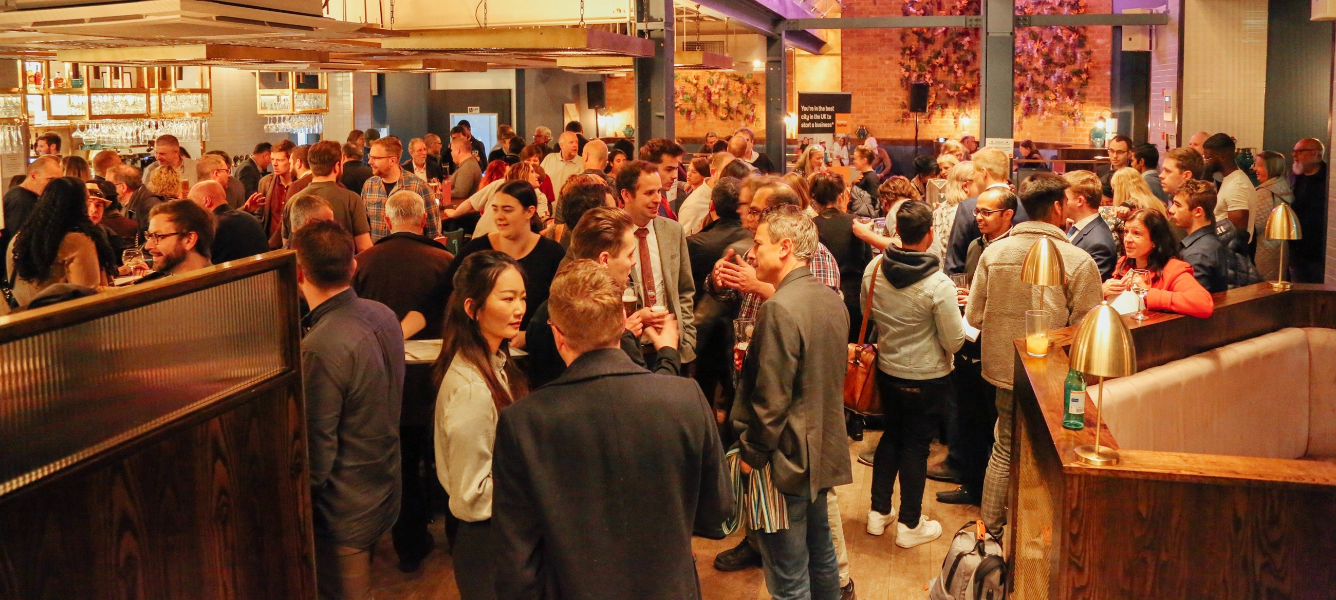 Entrepreneurs mingle at a busy networking event. 