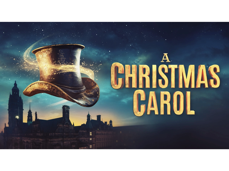A night sky at dusk with the silhouette of Sheffield's town hall building. In the foreground, a black Victorian top hat floats, swirled with a golden sparkly light. Text reads: A CHRISTMAS CAROL