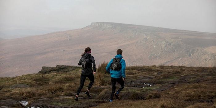 Two people on a city limits run route to Stanage Edge.