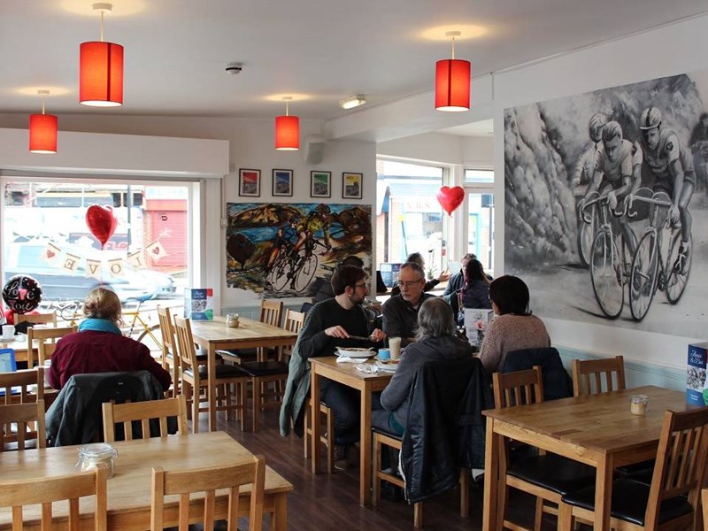 The clean, modern interior of Amici & Bici, with lots of cycling memorabilia.