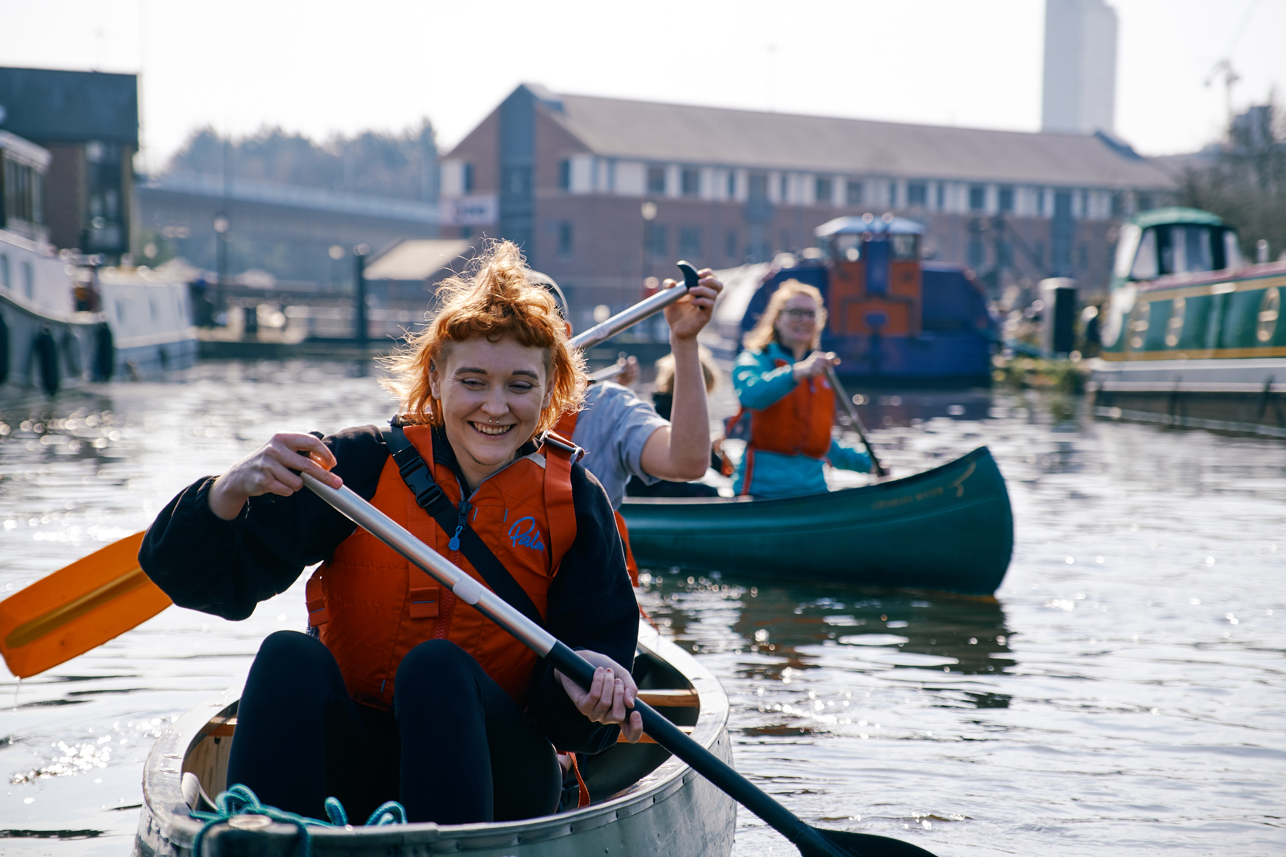 A group of people enjoying kayaking on the canal at Victoria Quays in Sheffield city centre. 