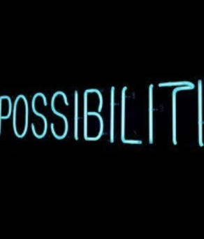 A blue neon sign reading 'expanding possibilities' on a dark background.