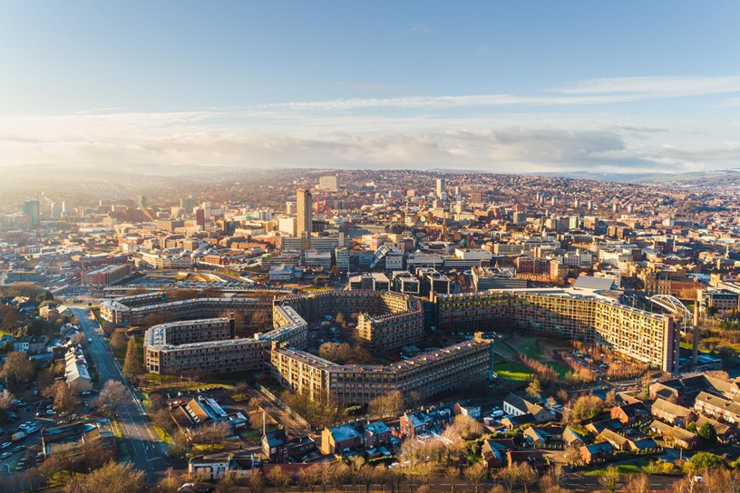 Drone  shot of Sheffield from above, looking down on Park Hill with the city centre directly behind