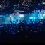 A blur-lit venue full of people dancing.