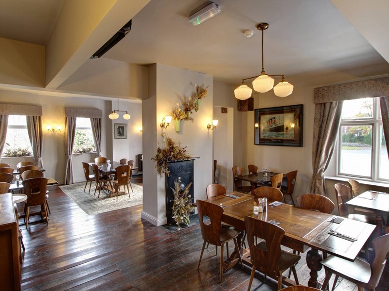 The interior of The Horse & Jockey with wooden floors and a bright and welcoming atmosphere.