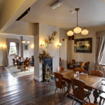 The interior of The Horse & Jockey with wooden floors and a bright and welcoming atmosphere.