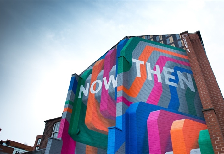 A huge colourful mural with the words 'Now Then' by Rob Lee, on Howard Street in Sheffield.