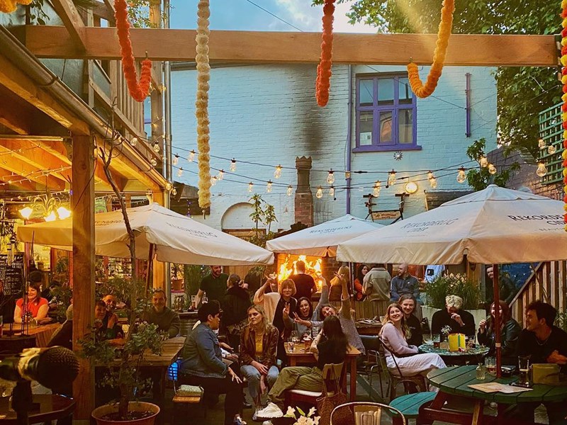 The courtyard at Haggles Coner, filled with people dining.