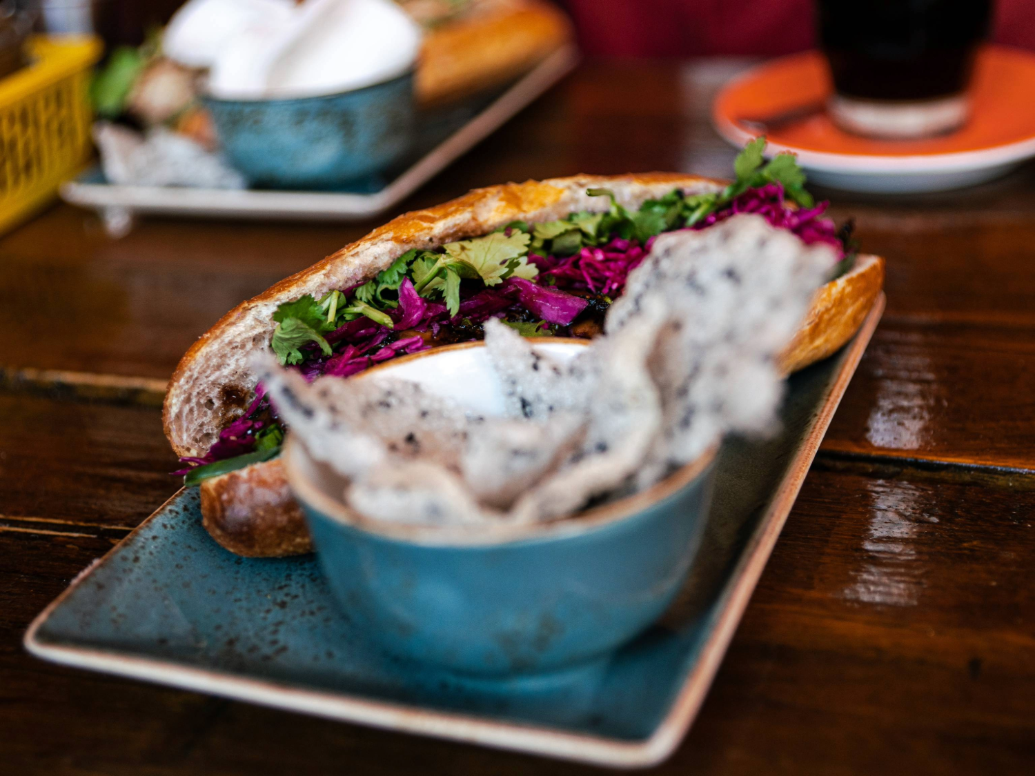 A close-up of several drinks and food dishes on a table.
