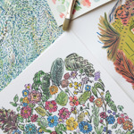 A close-up of colorful botanical illustrations on paper, including vibrant flowers, green leaves, and abstract foliage patterns. A paintbrush and a color swatch card with pastel tones are placed alongside the artwork, suggesting a creative painting process.