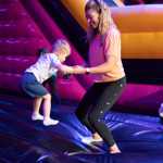 A woman and a young child jumping and having fun at Air Haus.