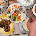 Plates of fresh Turkish food laid out on a table.