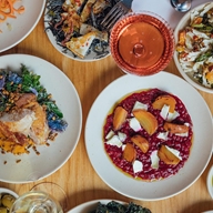 A table full of plates of food, shot from directly above.