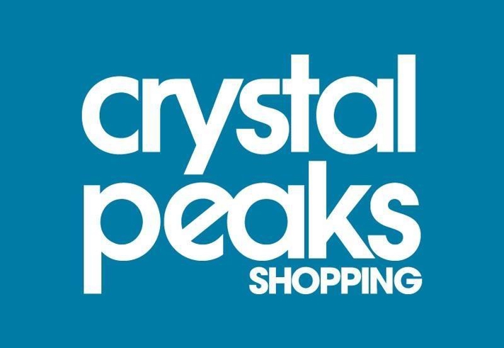 The Crystal Peaks Shopping centre logo which consists of the word Crystal Peaks Shopping, in white, on a blue background.