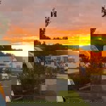 Sunset view over caravans at Waleswood Caravan and Camping Park with warm evening light