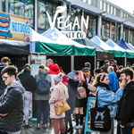 A large crowd of people looking round the stalls at the Sheffield Vegan Market on The Moor.