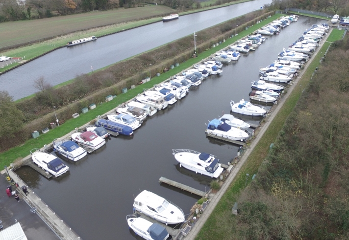 Two rows of boats in a marina.