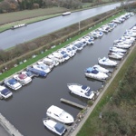 Two rows of boats in a marina.