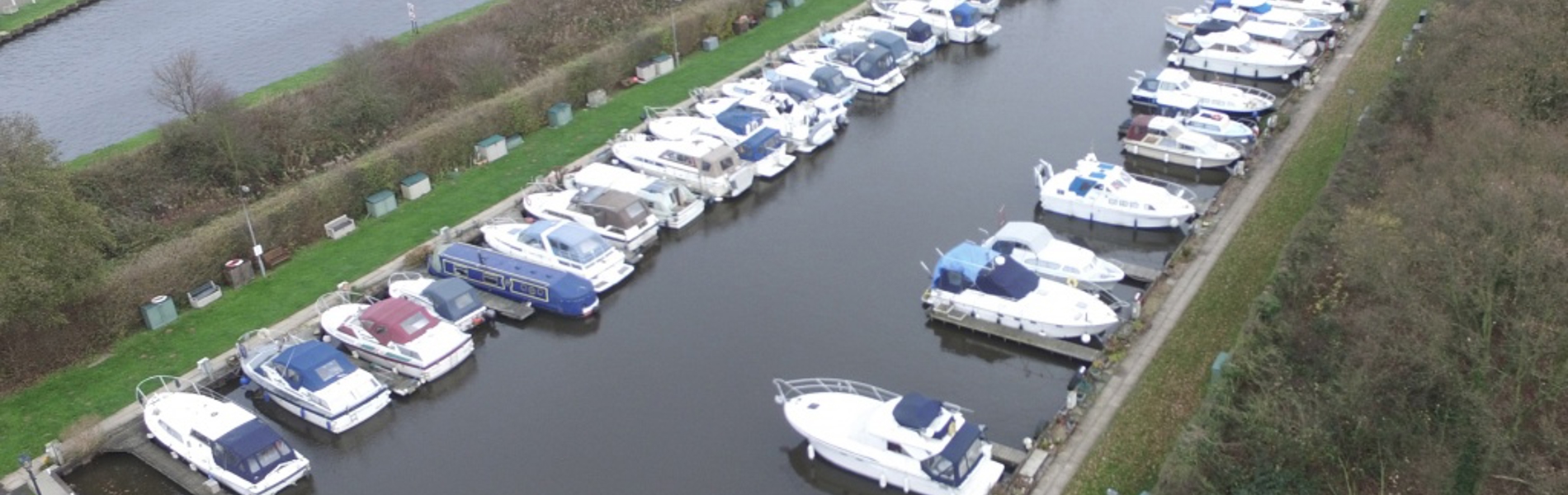 Two rows of boats in a marina.