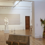 Inside Graves Gallery a woman looks at a marble statue.