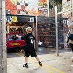 A woman and a boy playing football at Yard Ball.