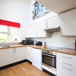 Interior view of a kitchen area with countertops, cabinets, sink, and appliances.