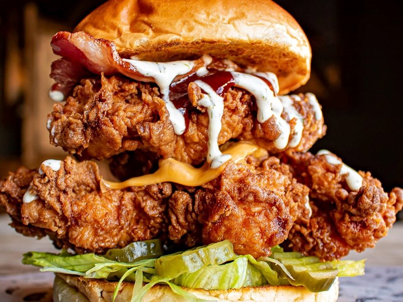 A double chicken, bacon and cheese burger.