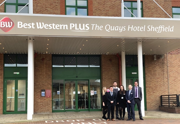 Members of staff  pose for a photo outside the entrance to The Quays Hotel.