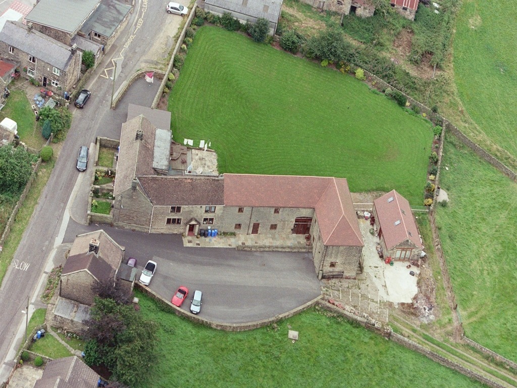 Aerial view of Padley Farm showing the exterior and surrounding landscape.