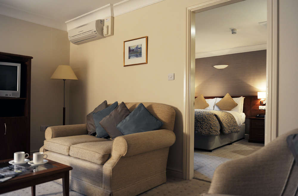 Sitting area at Mercure Tankersley Manor with comfortable chairs and a small table.