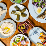 Plates of fresh Turkish food laid out on a table.