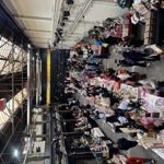 A busy indoor market with lots of stalls.