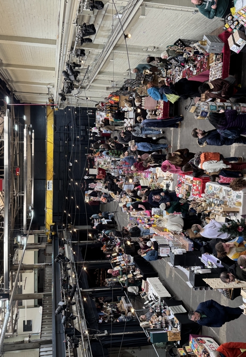 A busy indoor market with lots of stalls.