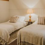 Bedroom with a double bed, bedside table, and soft lighting